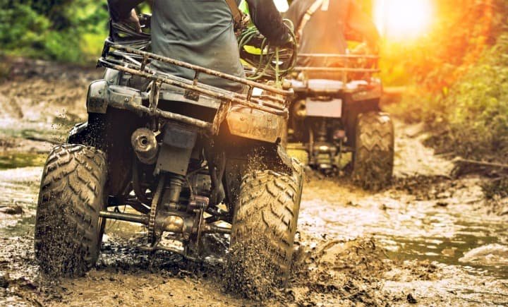 ATVs going through mud. ATVs going through mud.