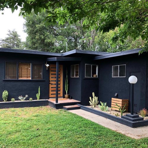 modern black house with backyard