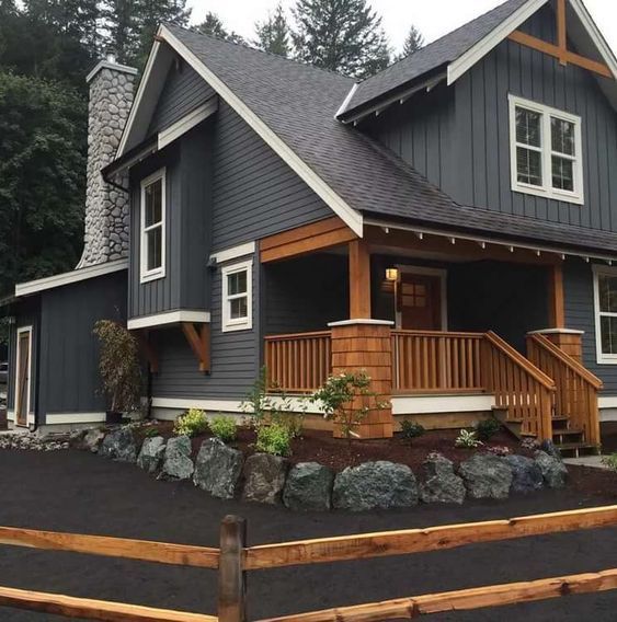 dark gray house with cedar patio and railing