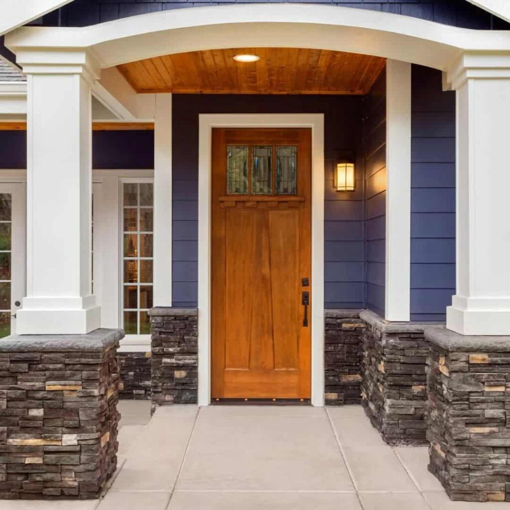 gray house with cedar door and white trim