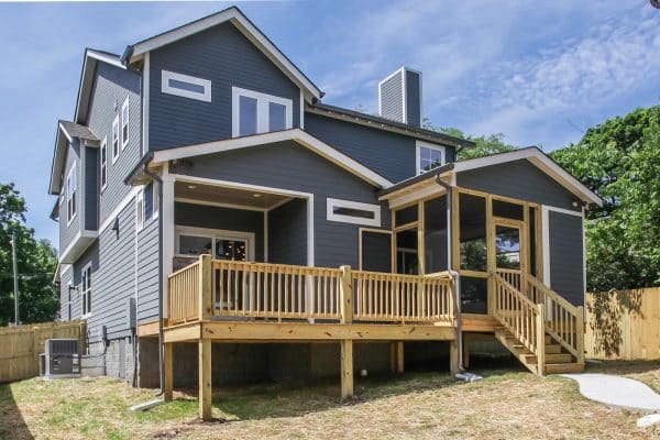 gray house with cedar balcony railing and white trim