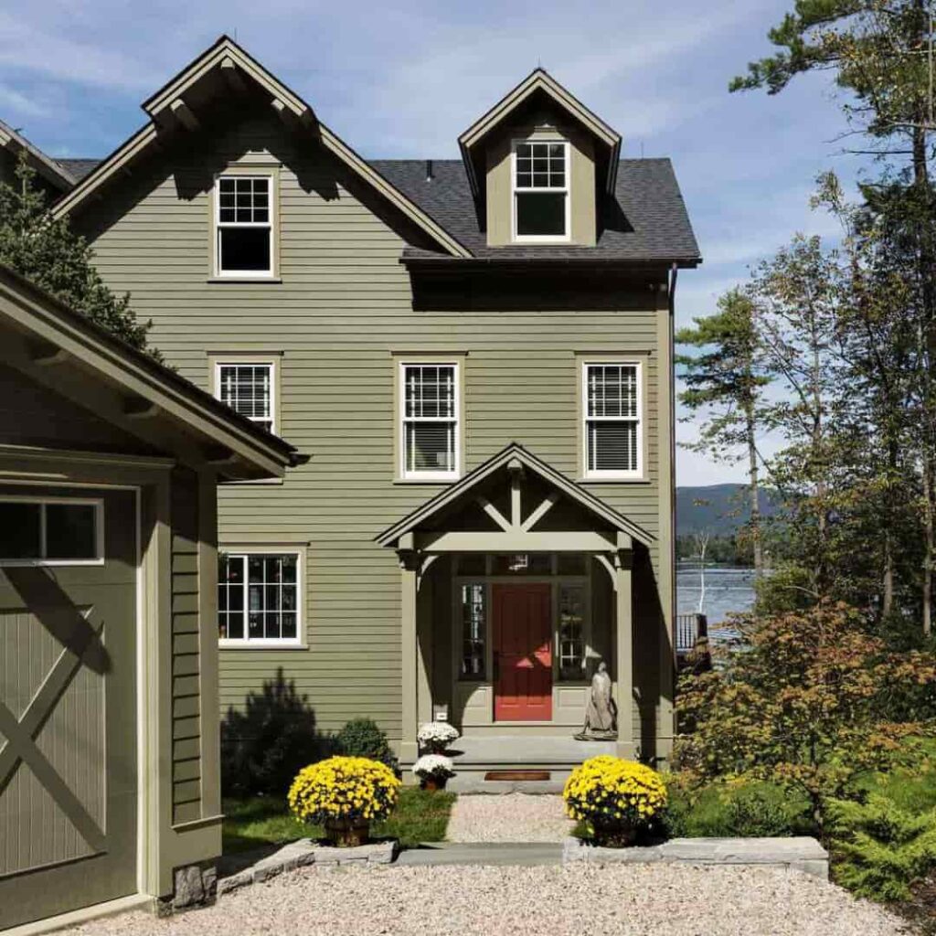 an image showing olive green house with black trim and accents