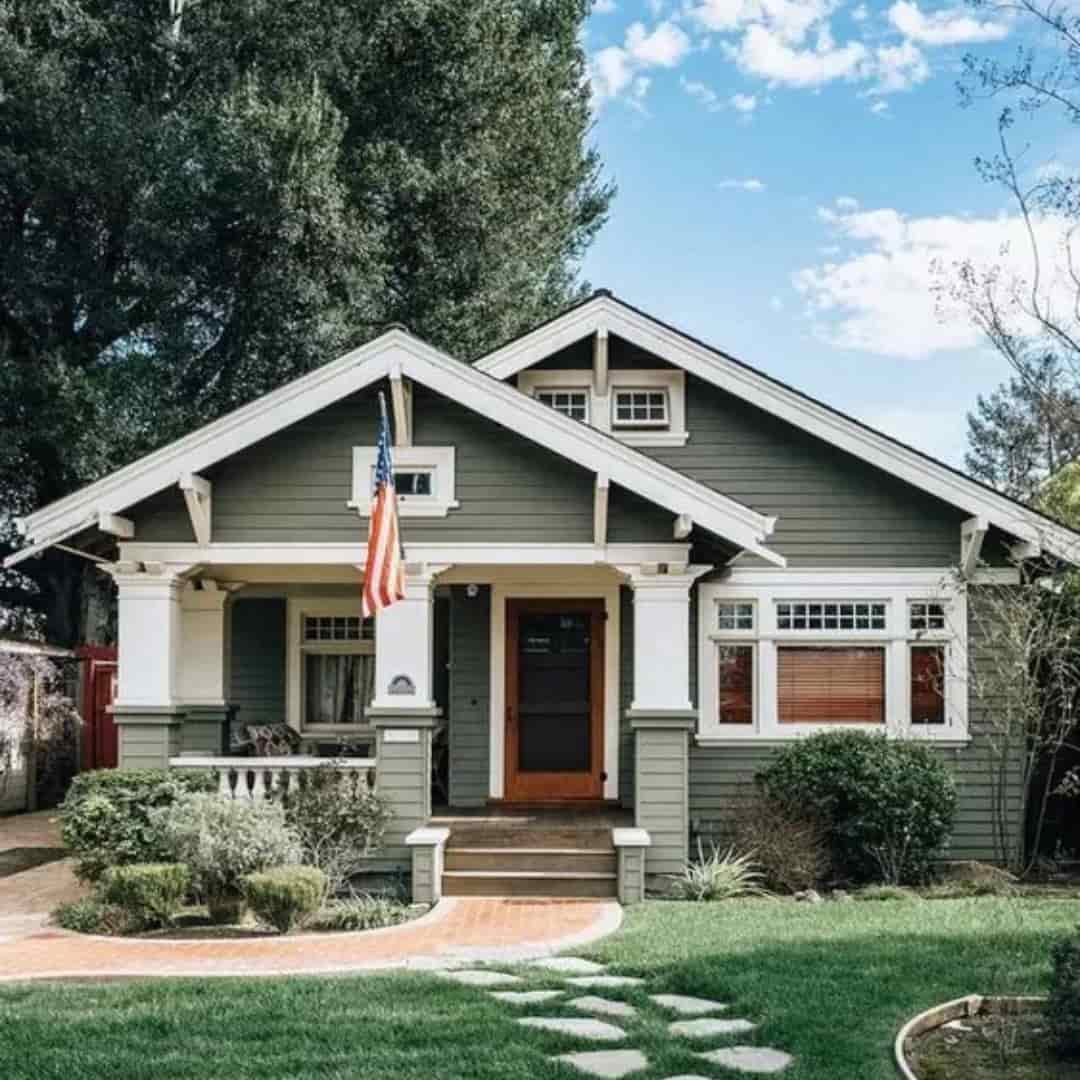 white windows and doors on sage green house