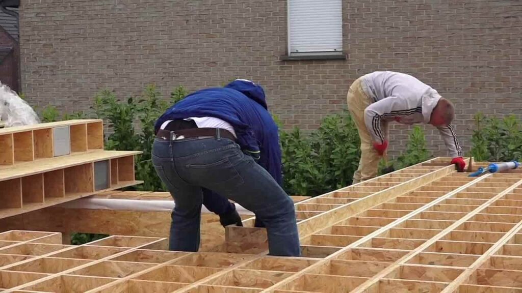 an image showing 2 people constructing a house using gablok insulated blocks
