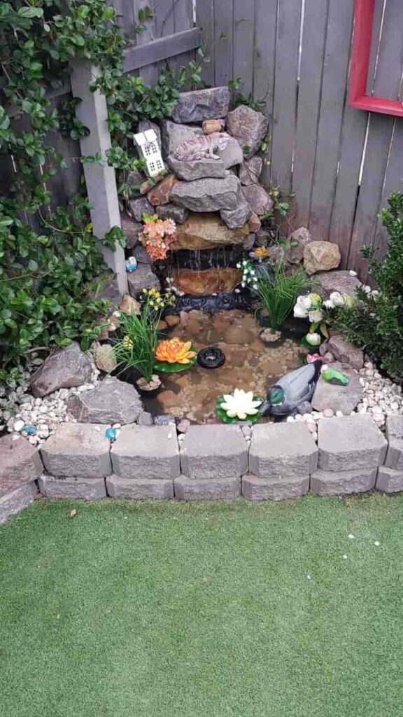 an image of a small corner garden with pond
