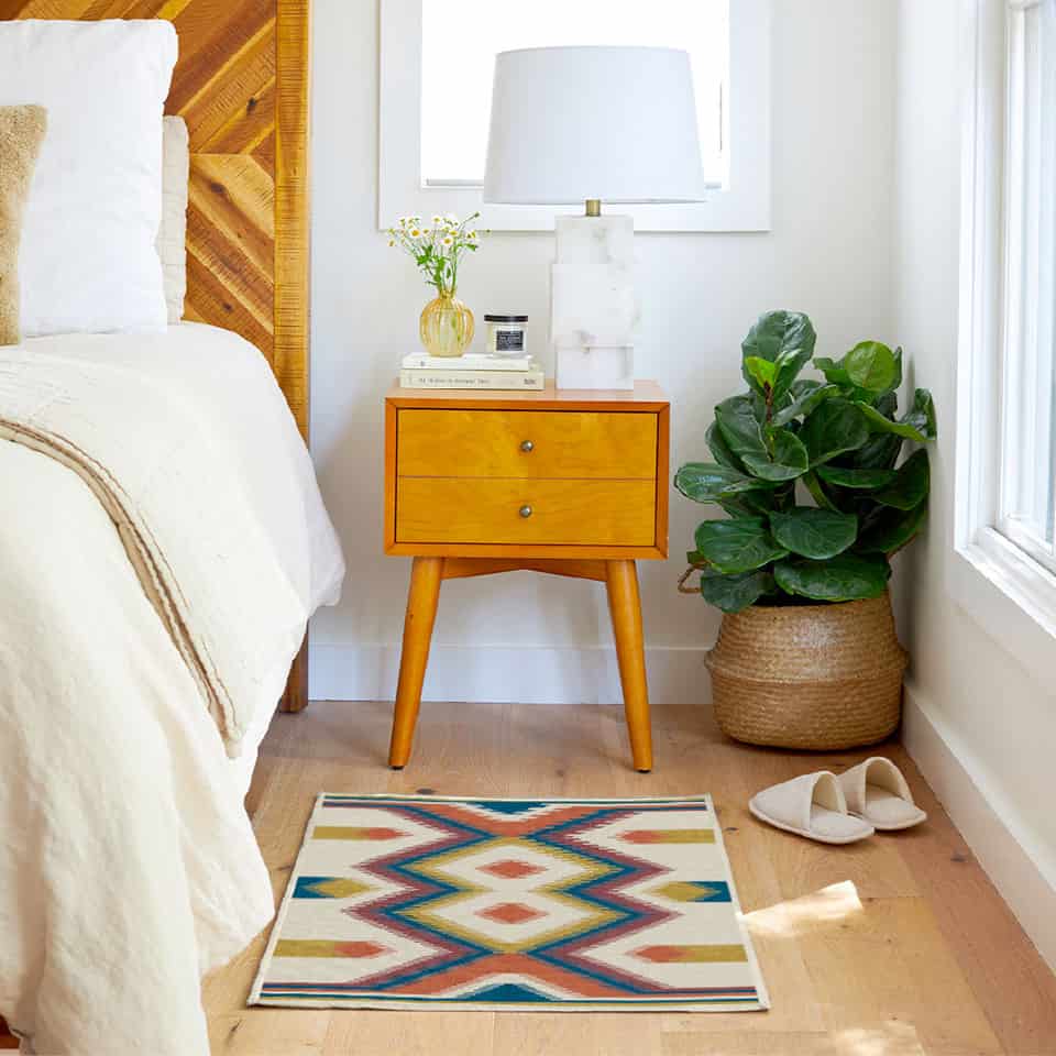 image showing 4x6 rug placed beside a bed