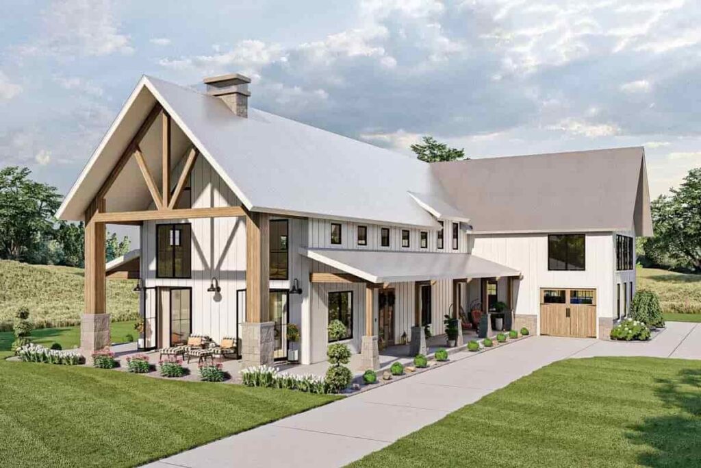 a white barn house with wood accent on columns, doors, and windows