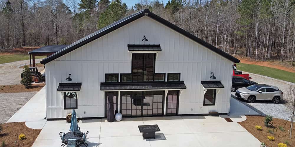 front view of a white barndominium with black accent