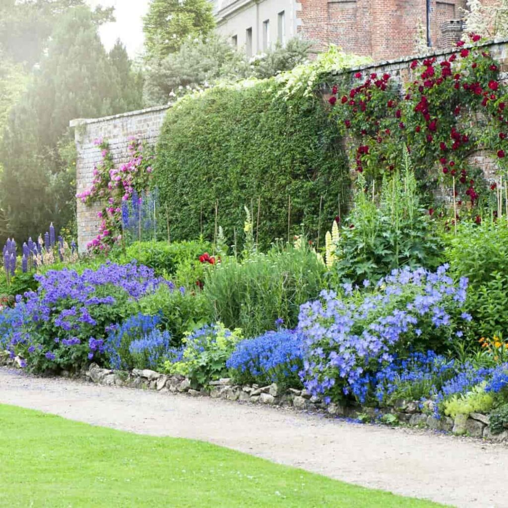 an image of flower boder on a pathway of a fairytale style garden