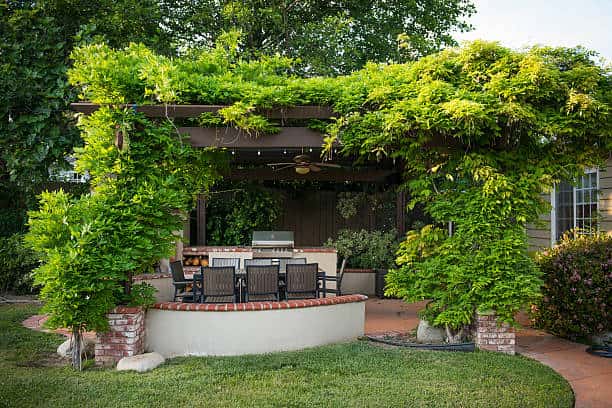 a green patio roof with planters