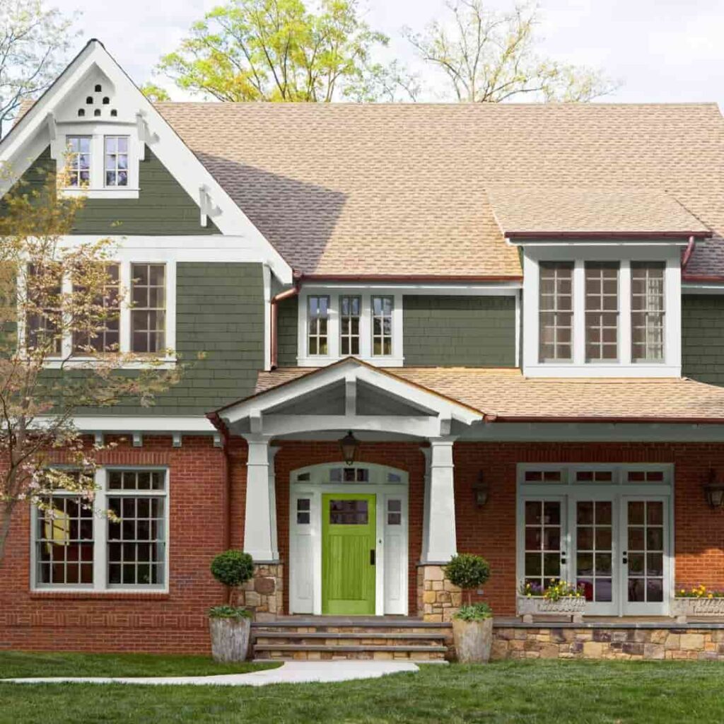 an image of a half sage green and half red brick with brown roofing
