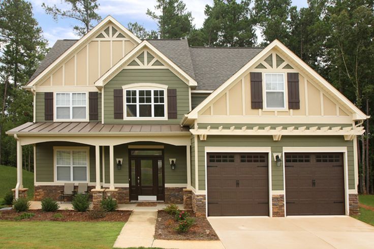 an image showing sage green house with brown garage door and shutters