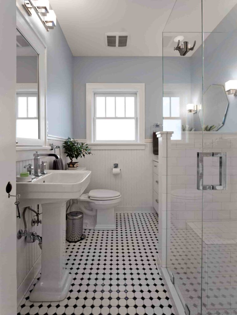 an image of a spacious 10x10 bathroom layout with enclosed shower, large sink, and toilet