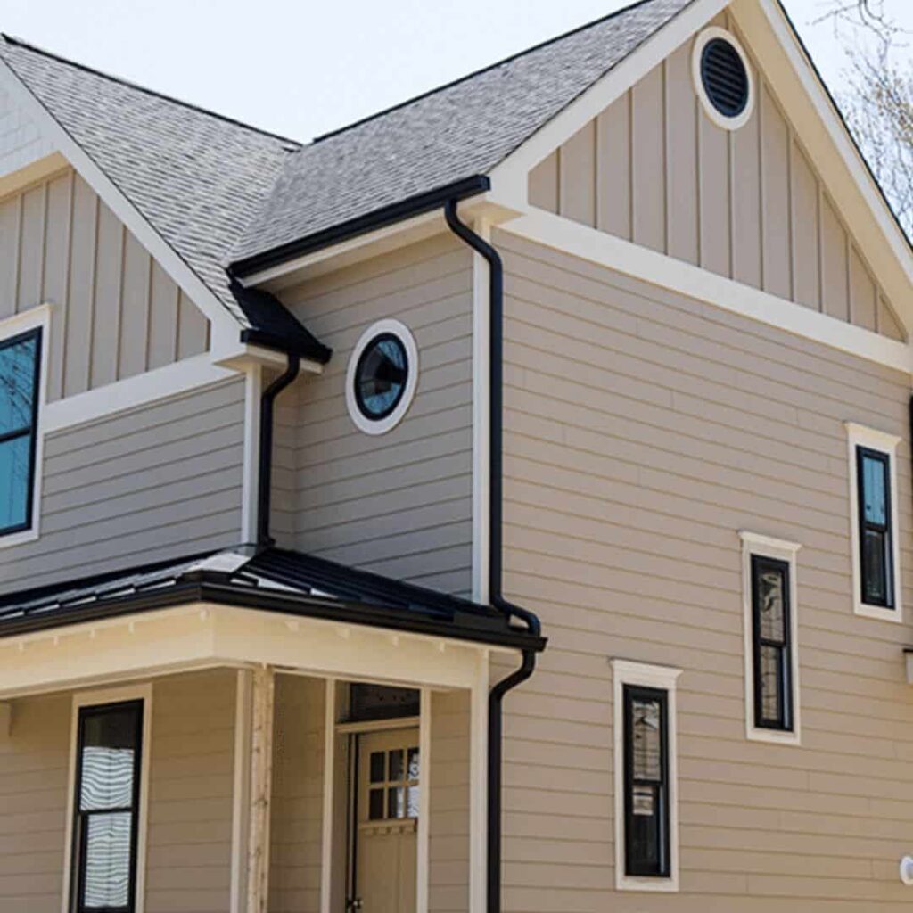 image showing Tan house with black gutters