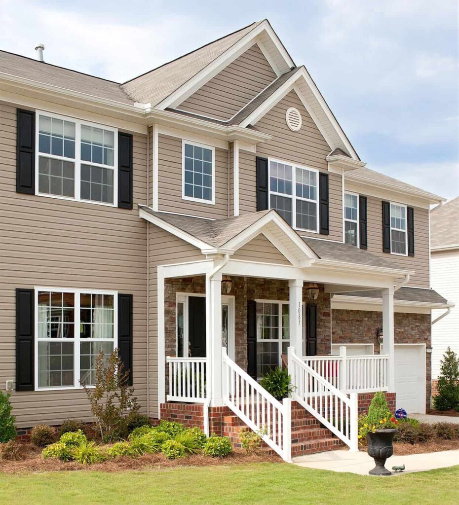 an image of a tan house with black and white trims