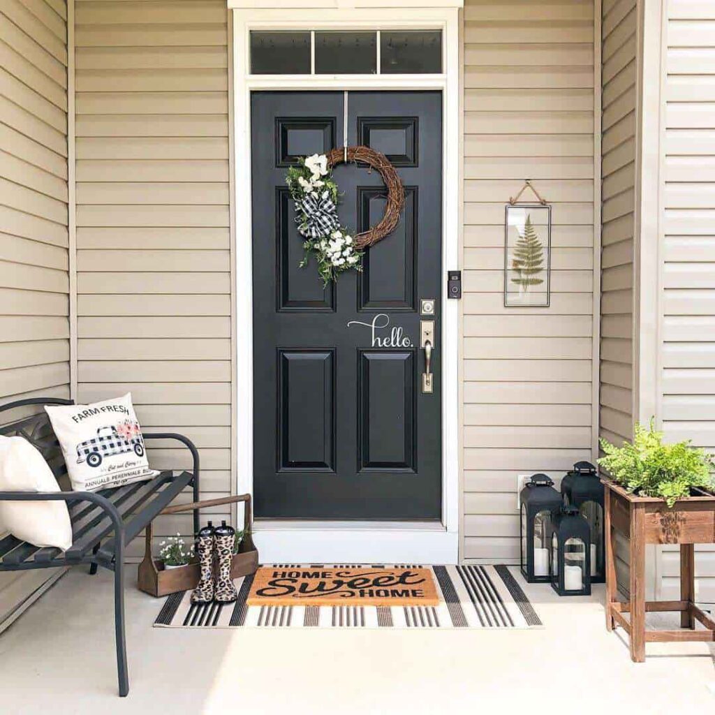 an image showing Tan siding with black front door
