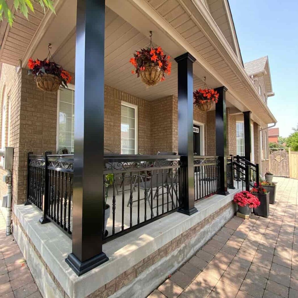 an image of a Tan house with black porch columns