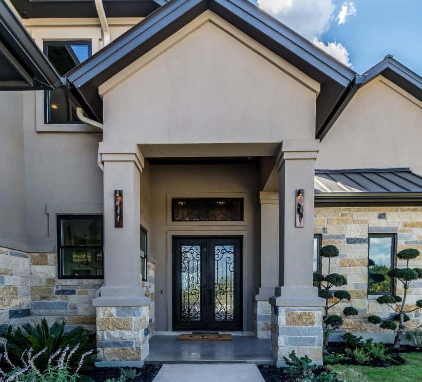 an image of a Tan stucco house with black trim