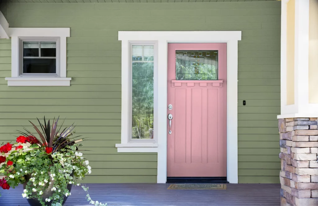 sage green house with Pink Front Door