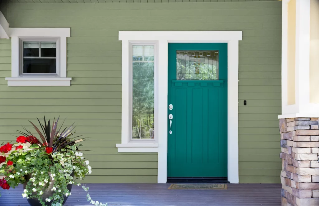 sage green house with Teal Front Door