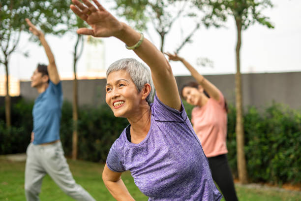 The elder lady doing yoga in the morning 