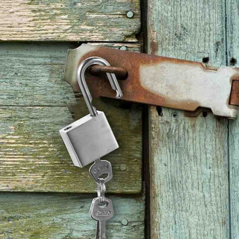 Silver color padlock and key on the door