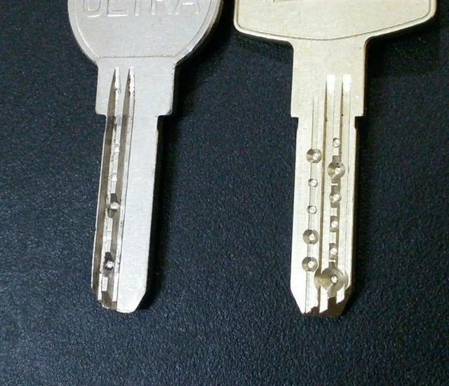Two silver color dimple key on a black background 
