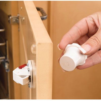 White colored magnetic key on a cabinet door 