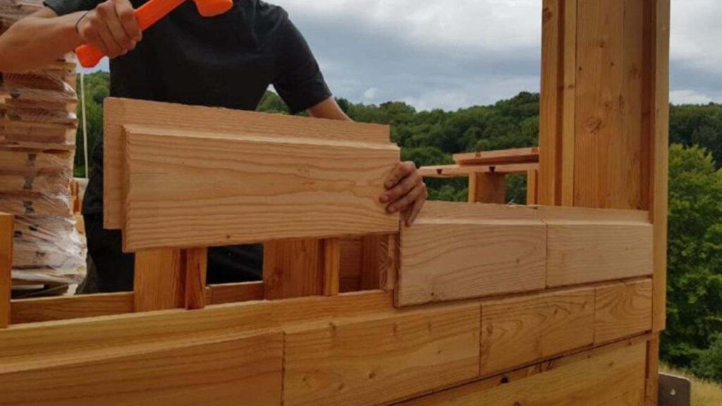 A person stacking block of brikawood kit