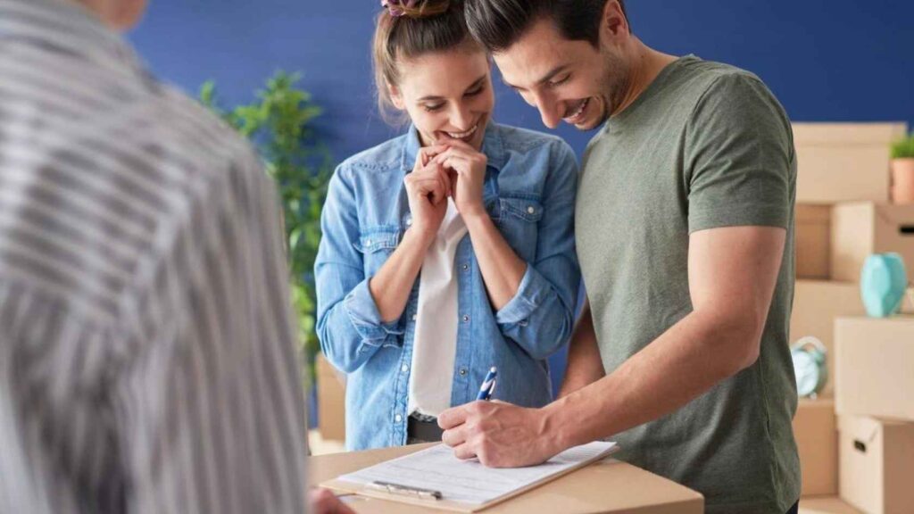 A women and a man signing some papers 