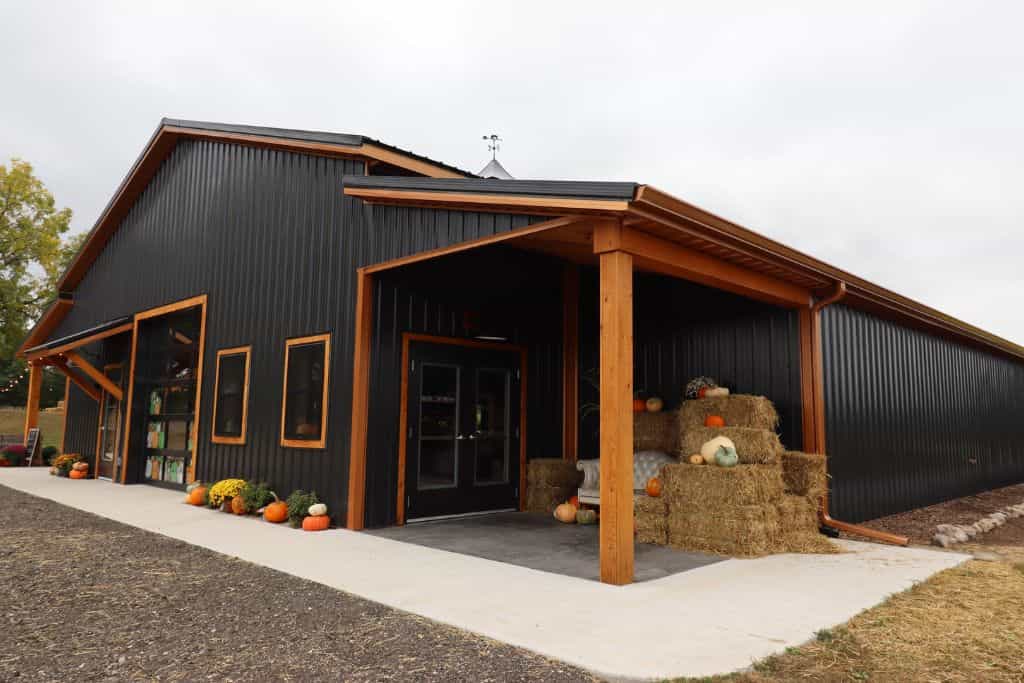 black barndominium with wood trim