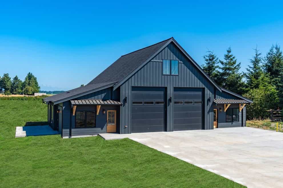 black barn house with garage doors
