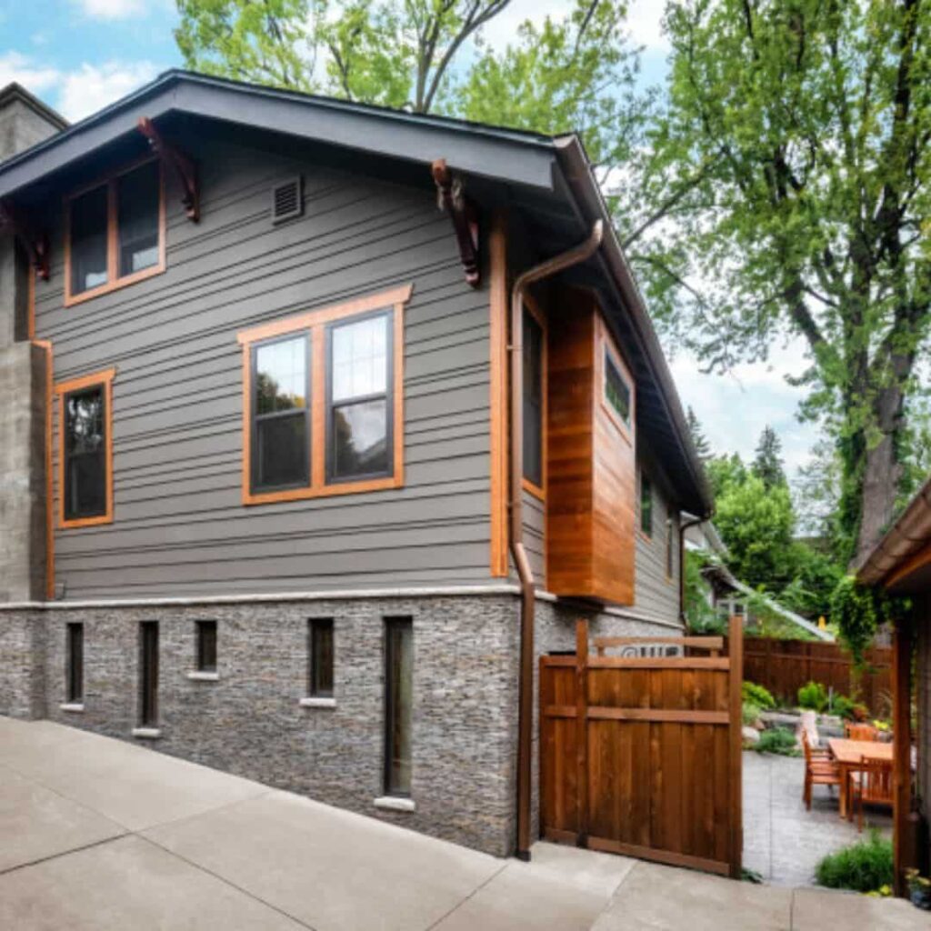 gray house with cedar window trim