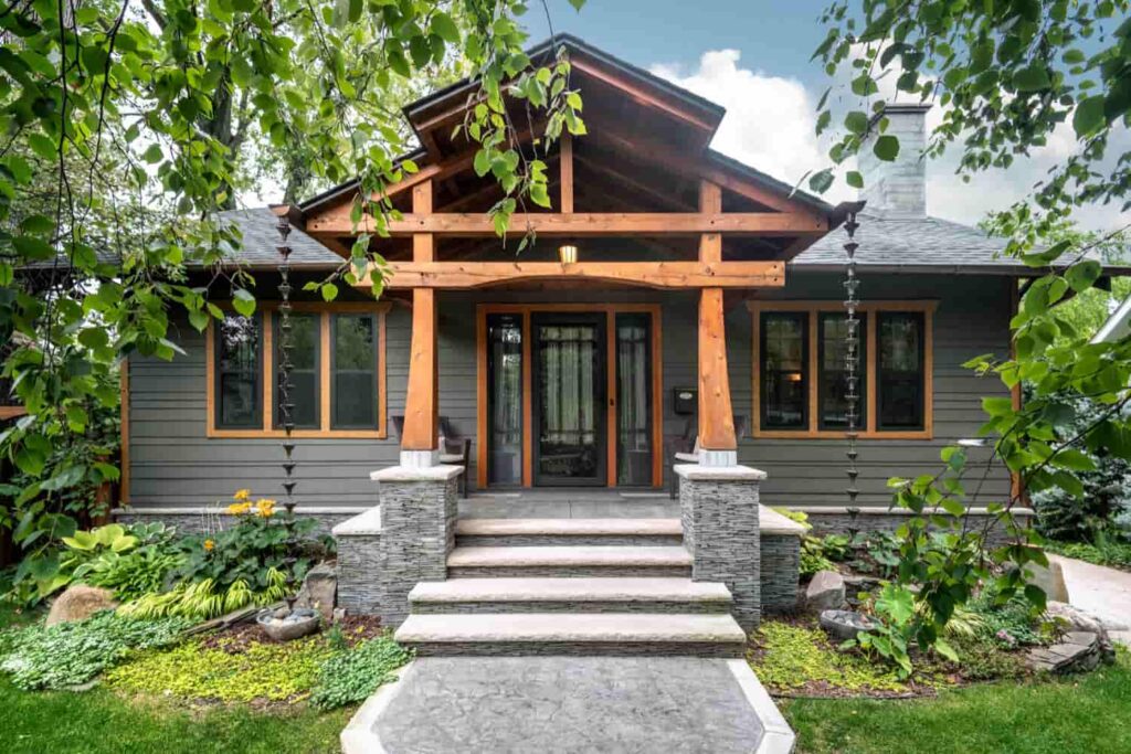 a beautiful front view of a grey house with cedar roofline and cedar trim