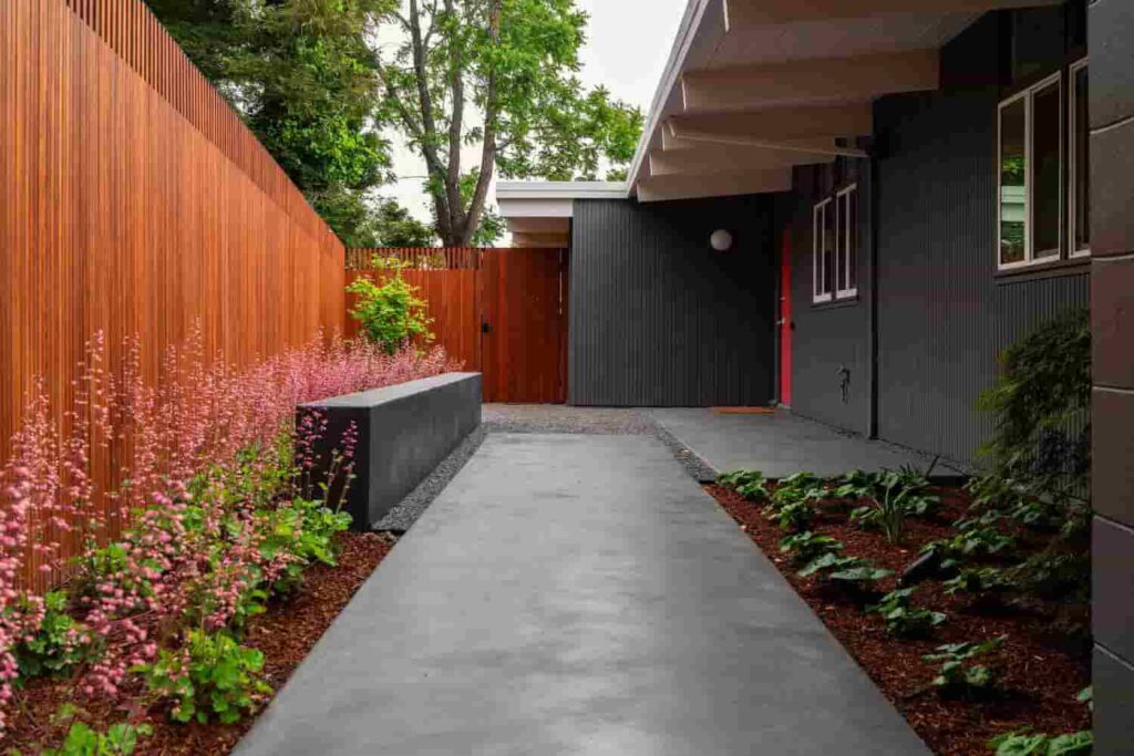an interior view of a grey house having cedar large fence