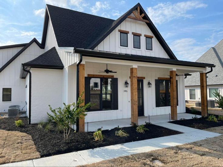 White House with Black trim and wood accents