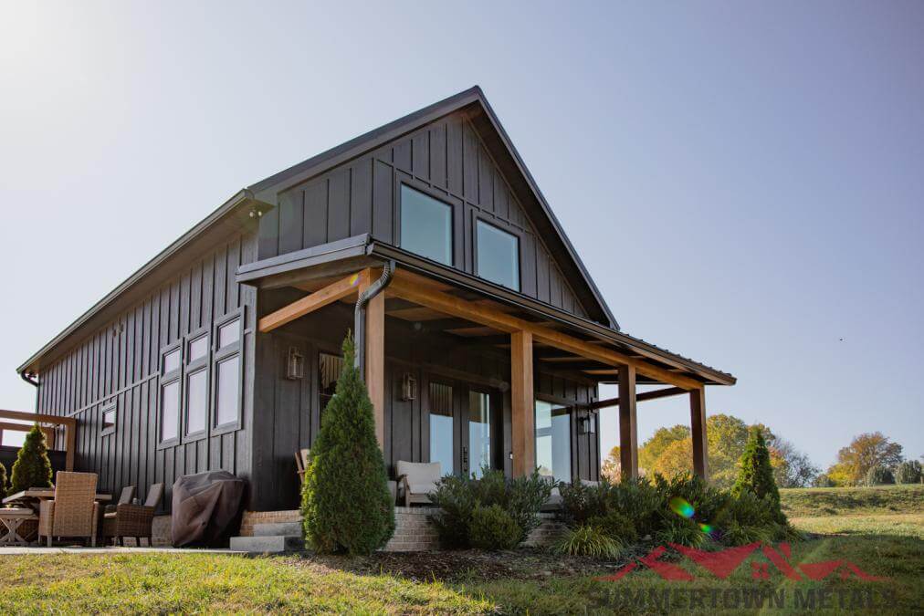 black barndominium with wooden porch