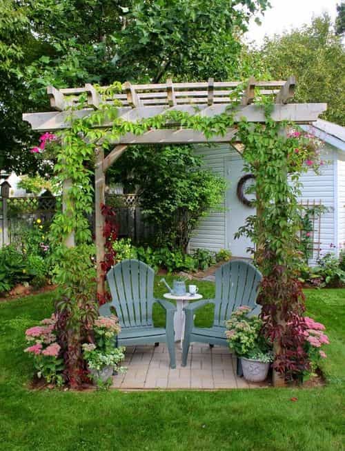 an image of a beautiful wooden pergola with chairs, inspired from fairytale themed english cottage garden