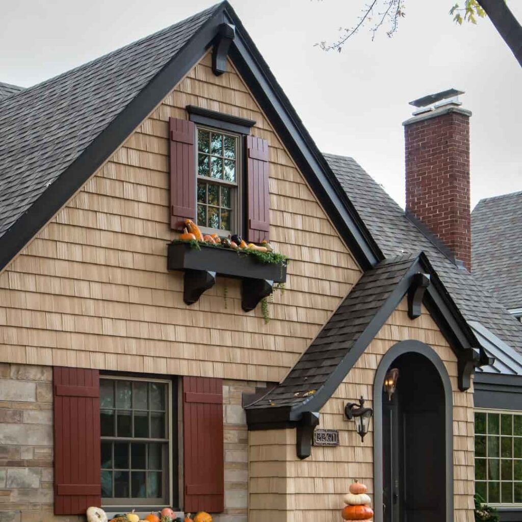 an image of Tan brick house with black highlights