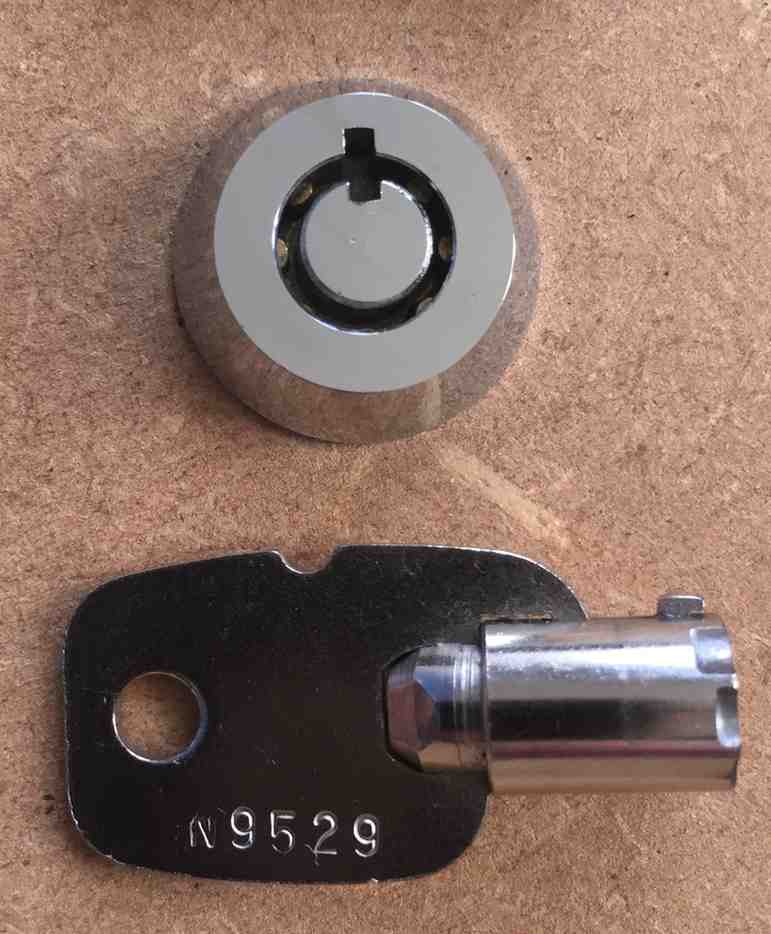 A tubular key on a cardboard 